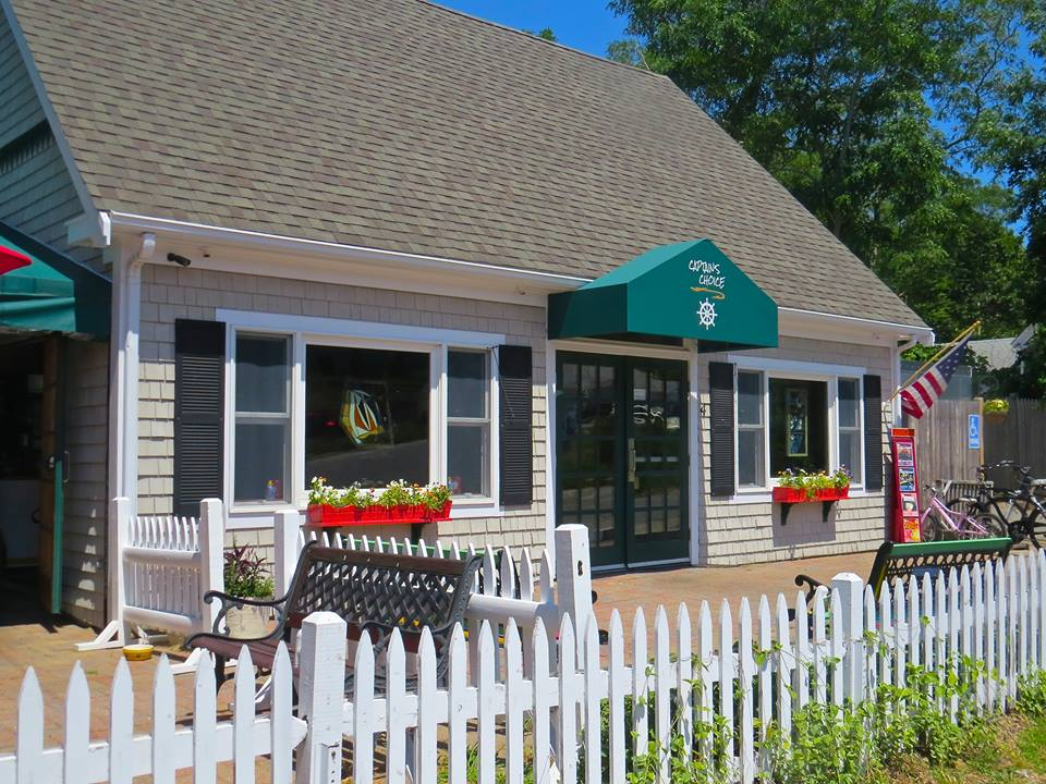 Captain’s Choice restaurant entrance in North Truro, with green awning and white picket fence